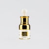 a gold bottle of YOUTH SERUM ELIXIR with a white lid on a white background.