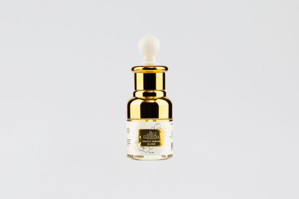 a gold bottle of YOUTH SERUM ELIXIR with a white lid on a white background.