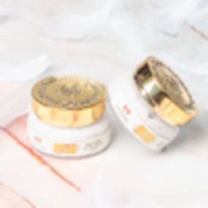 two jars of RECOVERY EYE CREAM sitting on a marble surface.