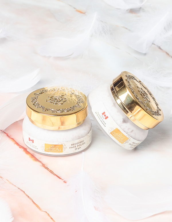 two jars of RECOVERY EYE CREAM sitting on a marble surface.